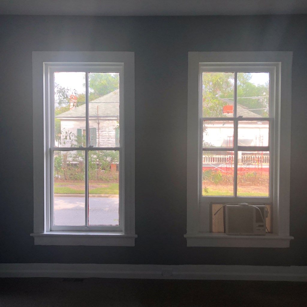 1345 18th Street Columbus, GA 31901 - Photo 15 of 16 a view of an empty room with wooden floor and a window