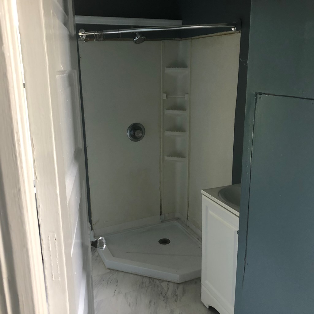 1345 18th Street Columbus, GA 31901 - Photo 16 of 16 a bathroom with a glass shower door