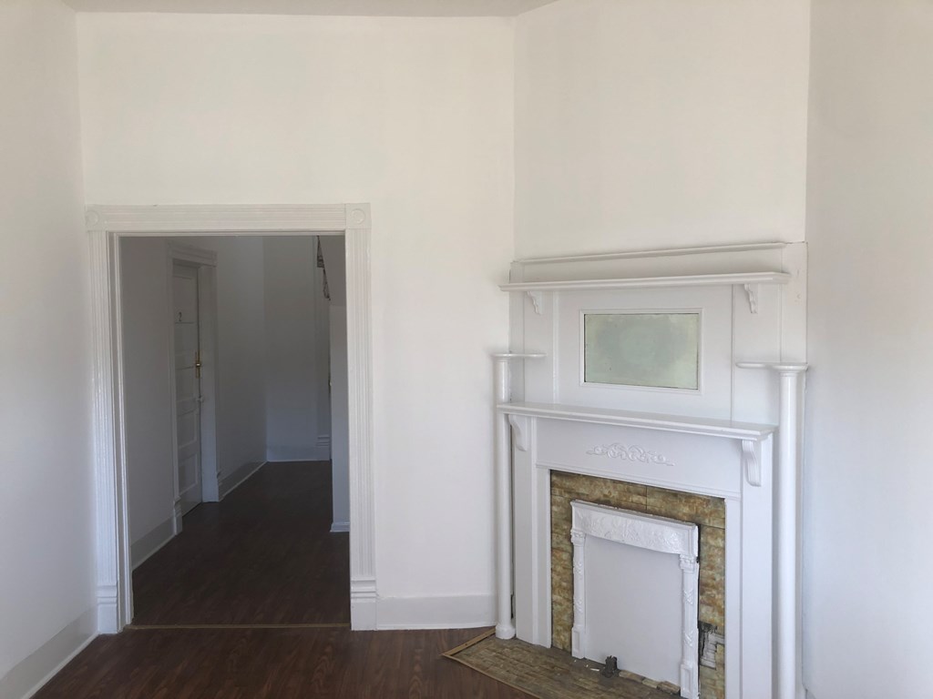 1345 18th Street Columbus, GA 31901 - Photo 5 of 16 a hallway with a fireplace and a mirror