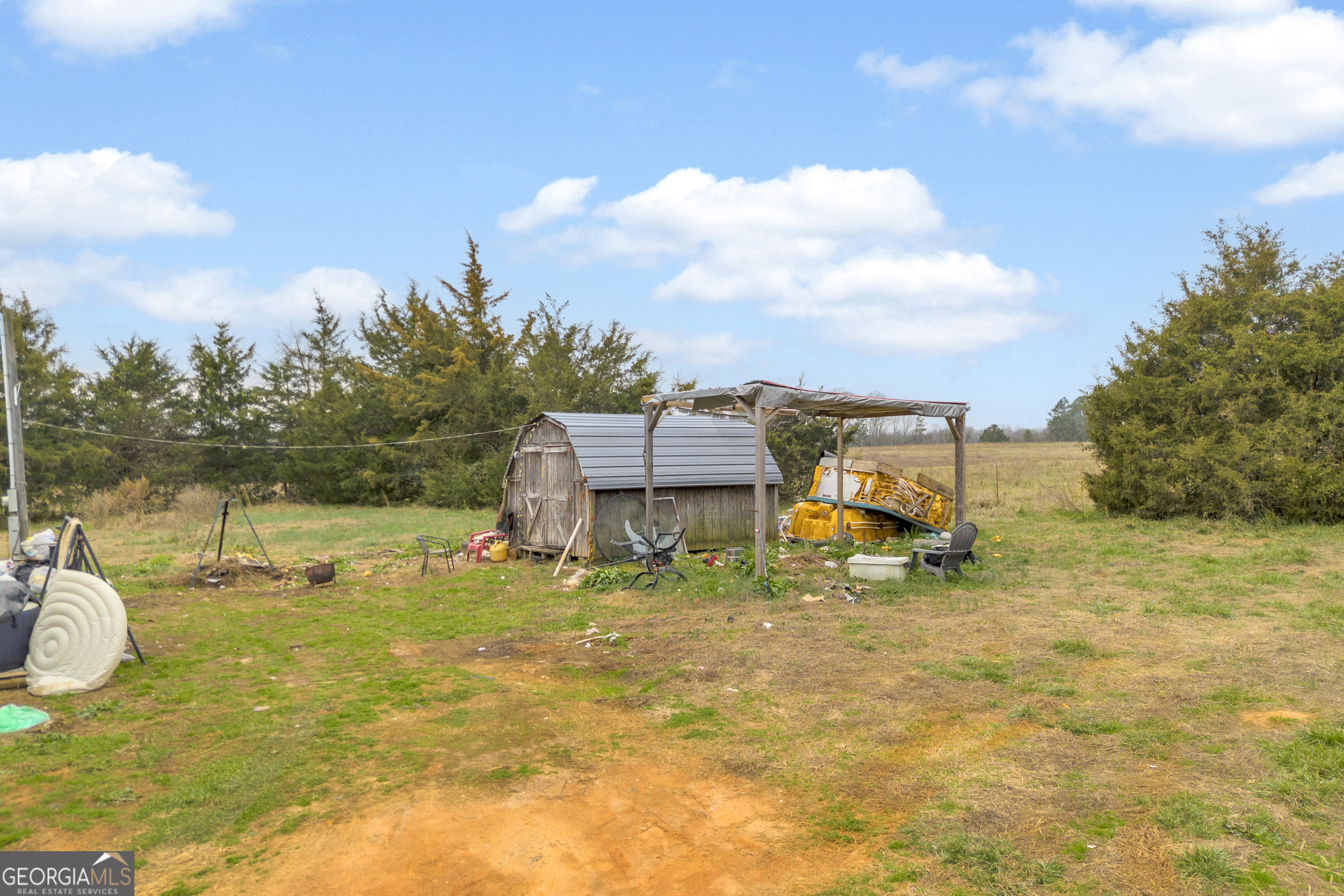 7743 Mt Olivet Road Hartwell, GA 30643 - Photo 28 of 42 a backyard of a house with table and chairs