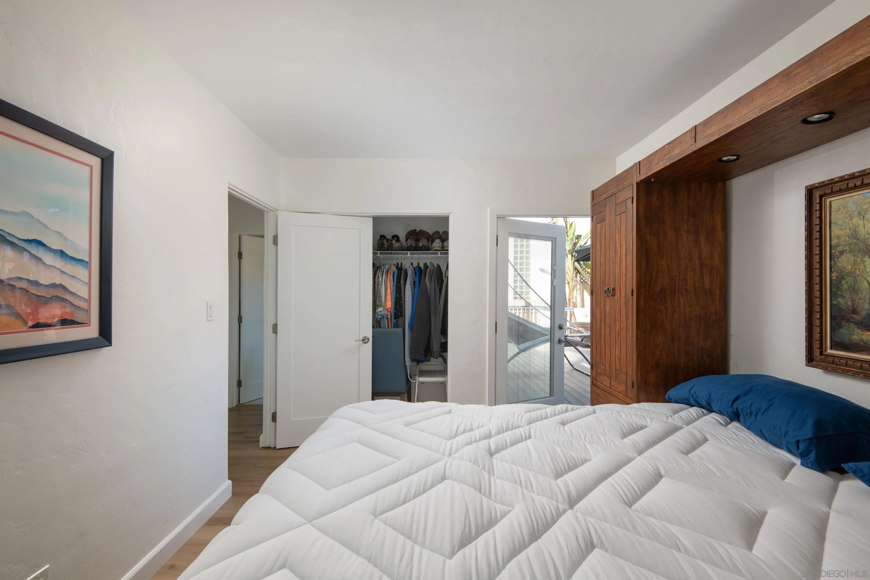 4484 Orchard Avenue San Diego, CA 92107 - Photo 23 of 36 a bedroom with a bed and a painting on the wall