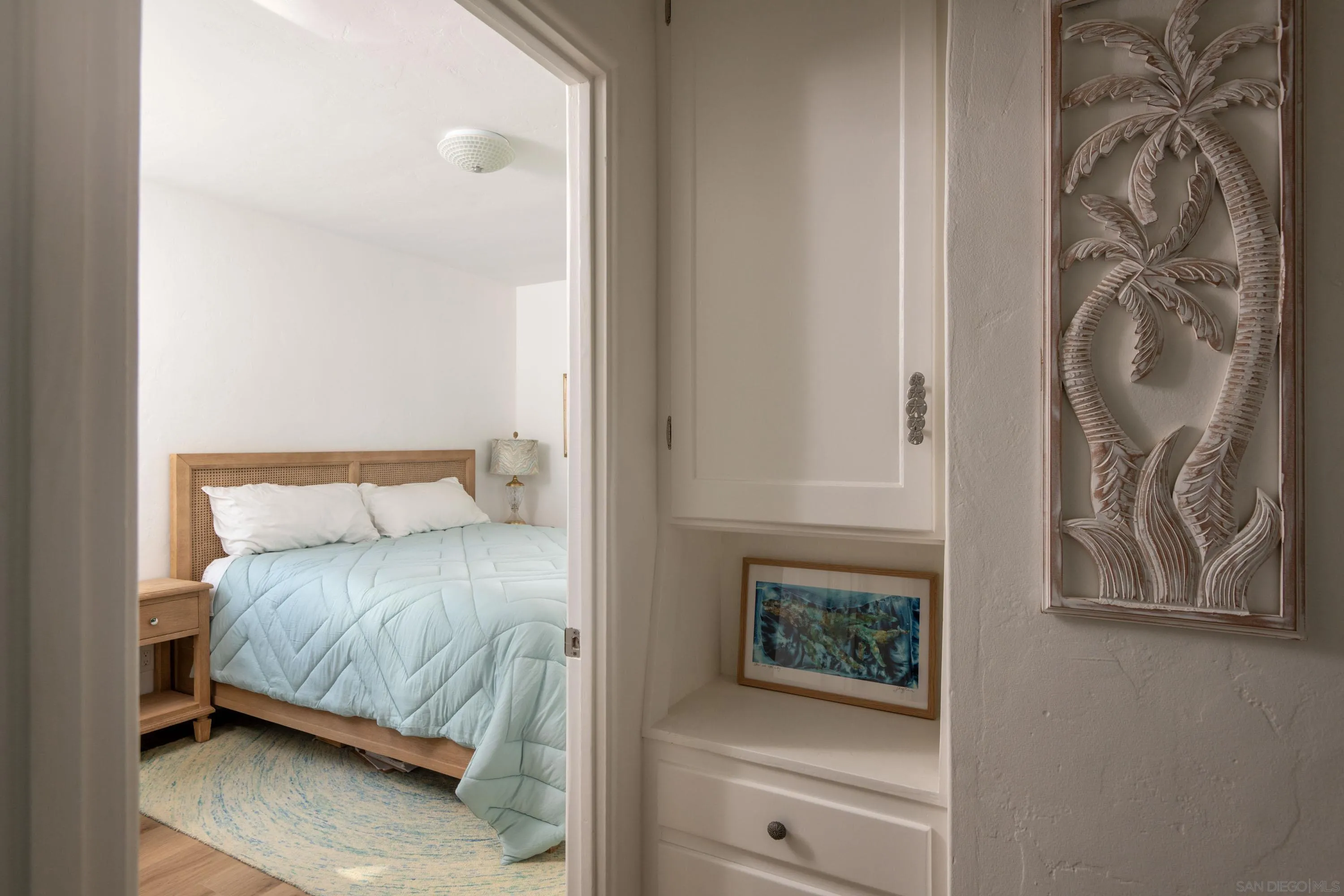 4484 Orchard Avenue San Diego, CA 92107 - Photo 24 of 36 a bedroom with a bed and a painting on the wall