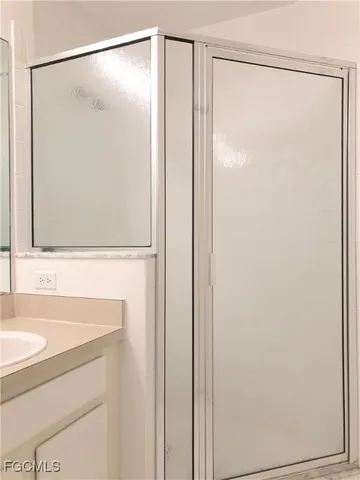 a bathroom with a shower and a sink