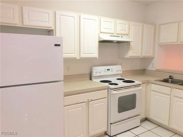 a kitchen with stainless steel appliances granite countertop white refrigerator stove a sink and dishwasher