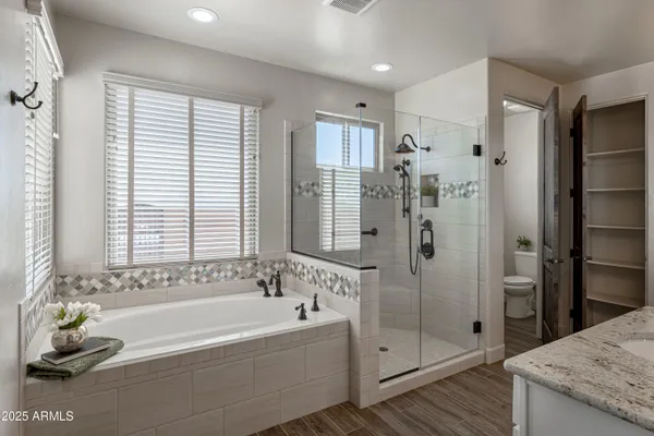 a bathroom with a tub sink and shower