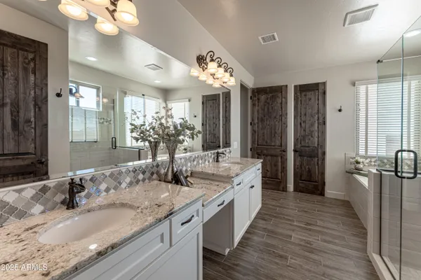 a view of empty room with wooden floor fireplace and a window