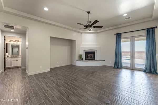 a living room with a fireplace and a potted plant