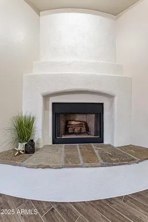 a view of a room with wooden floor and a fireplace