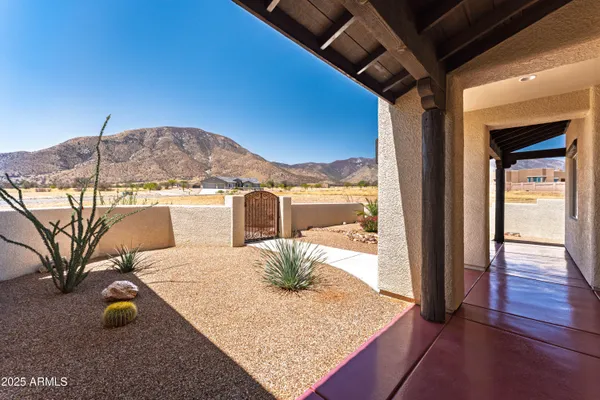 a view of a bedroom with a bed and wooden floor