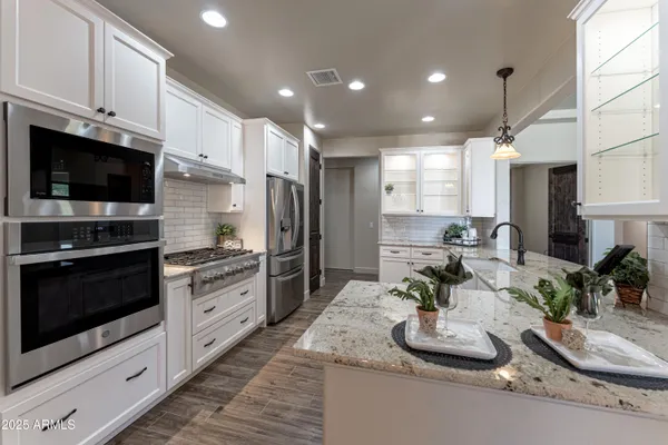a stove top oven sitting inside of a kitchen