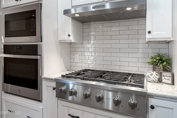 a kitchen with sink cabinets and wooden floor