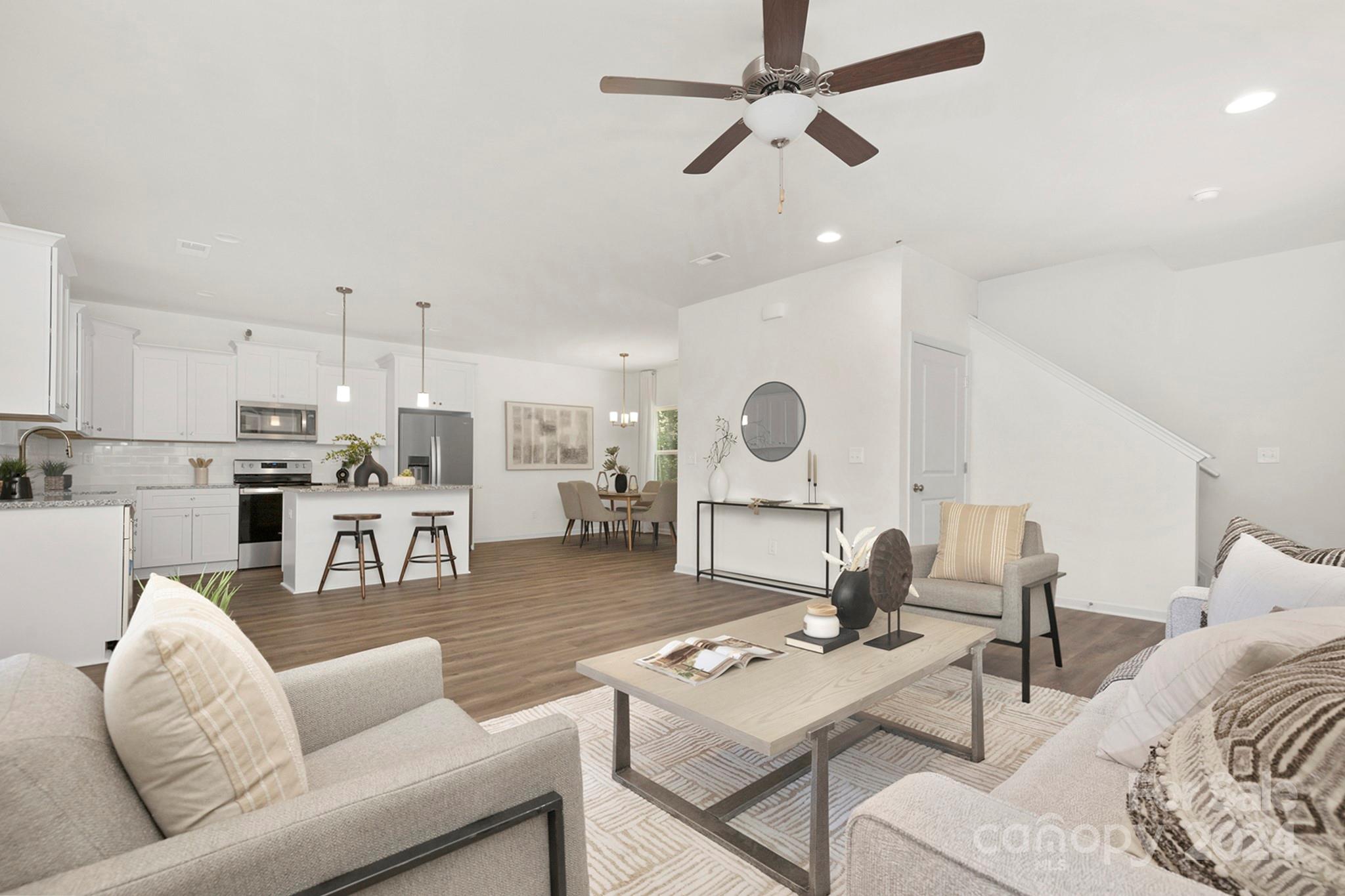 310 Morningside Road Charlotte, NC 28214 - Photo 2 of 23 a living room with furniture kitchen view and a chandelier