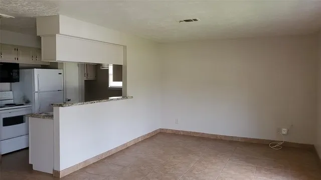 a kitchen with cabinets and refrigerator