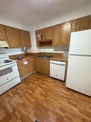 a kitchen with stainless steel appliances granite countertop a refrigerator sink stove and microwave