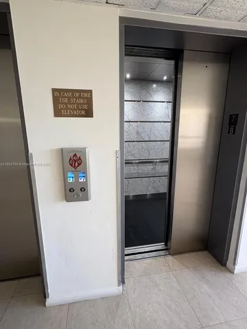 a view of multiple houses with a yard and potted plants