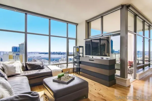 a living room with furniture large window and a table