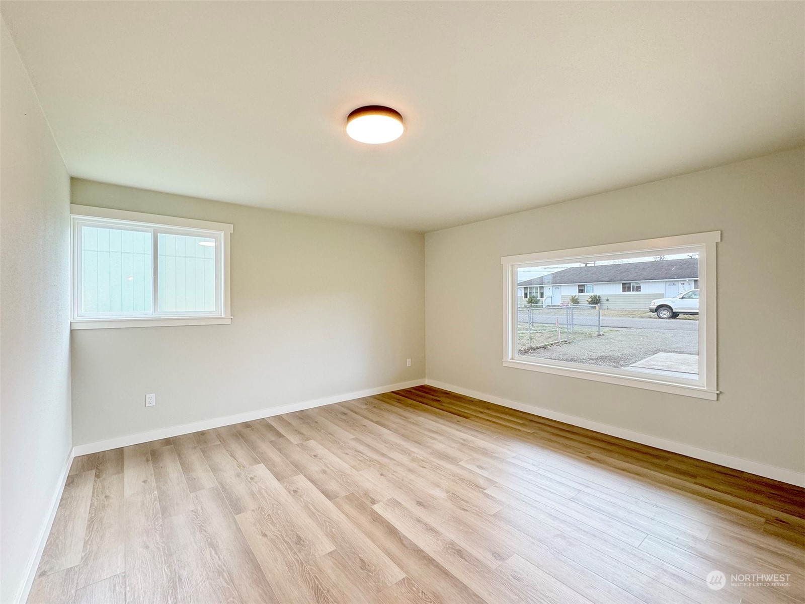 218 North Matriotti Avenue Sequim, WA 98382 - Photo 16 of 40 an empty room with wooden floor and window