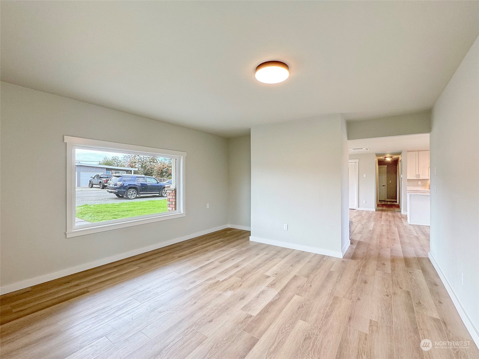 218 North Matriotti Avenue Sequim, WA 98382 - Photo 17 of 40 wooden floor in an empty room with a window