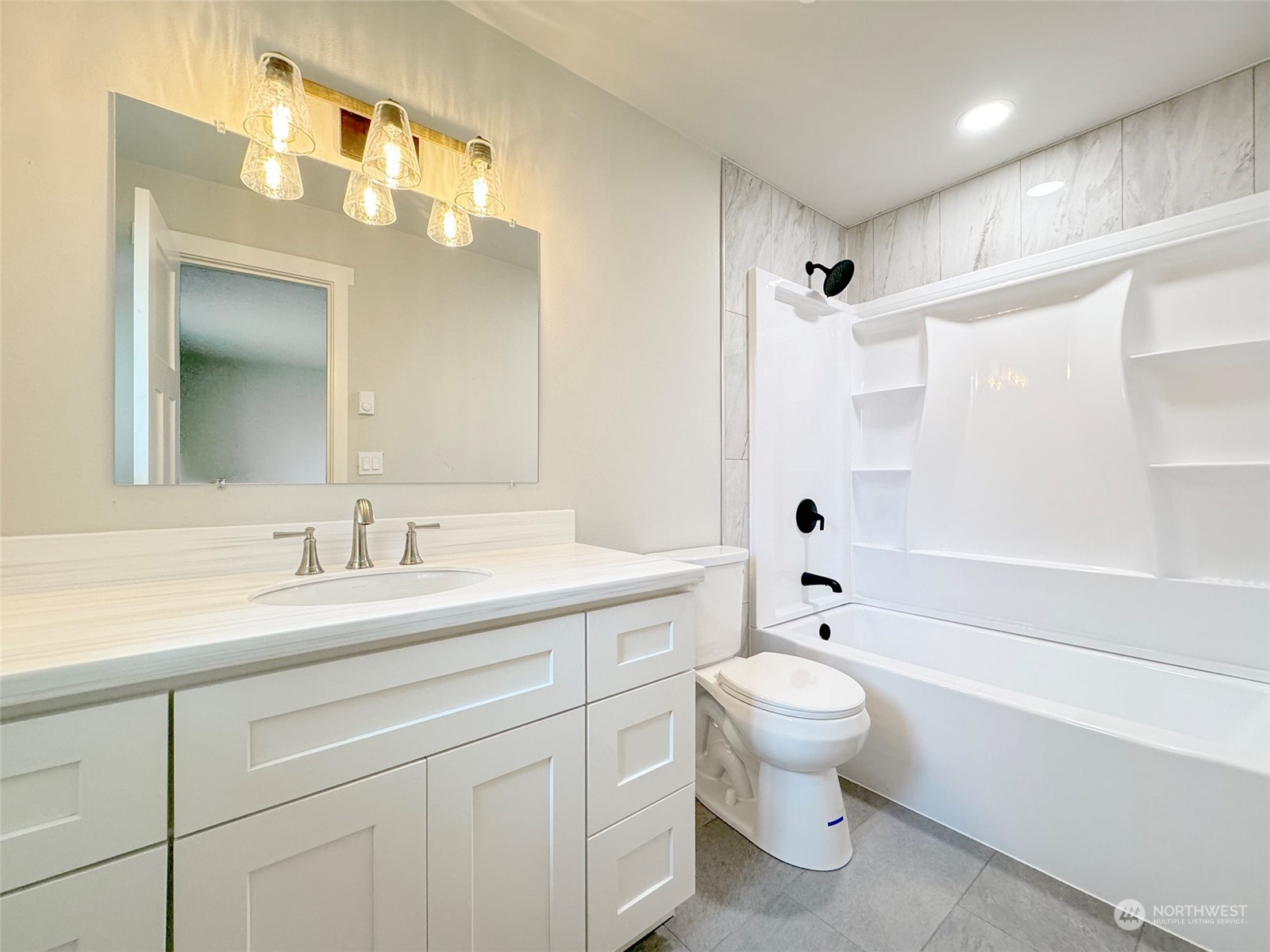 218 North Matriotti Avenue Sequim, WA 98382 - Photo 27 of 40 a bathroom with a toilet a sink a tub and mirror