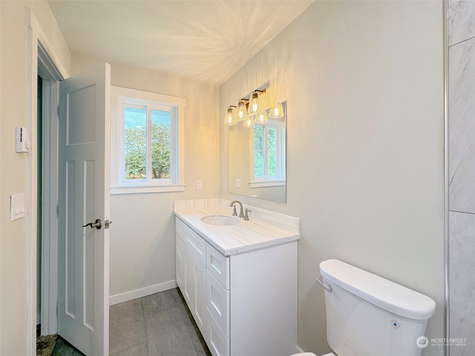 218 North Matriotti Avenue Sequim, WA 98382 - Photo 28 of 40 a bathroom with a sink toilet vanity and a mirror