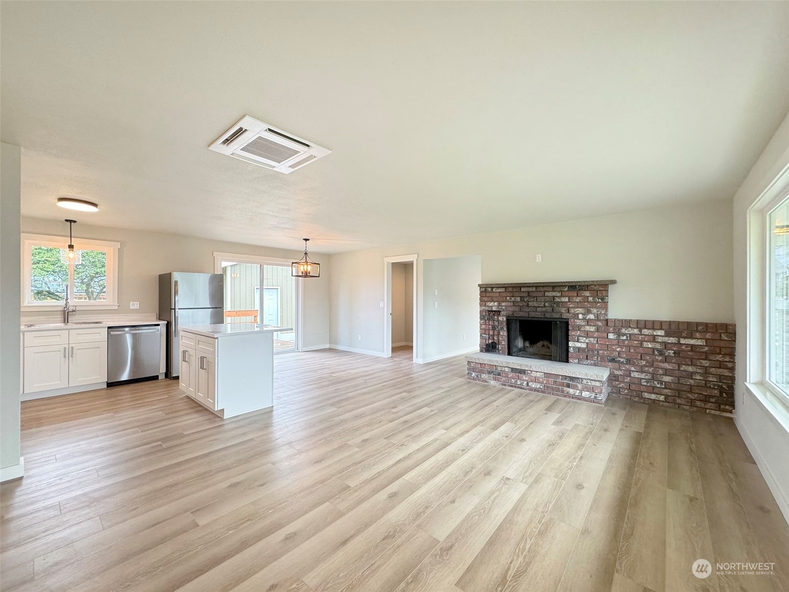 218 North Matriotti Avenue Sequim, WA 98382 - Photo 3 of 40 a view of empty room with wooden floor and fireplace