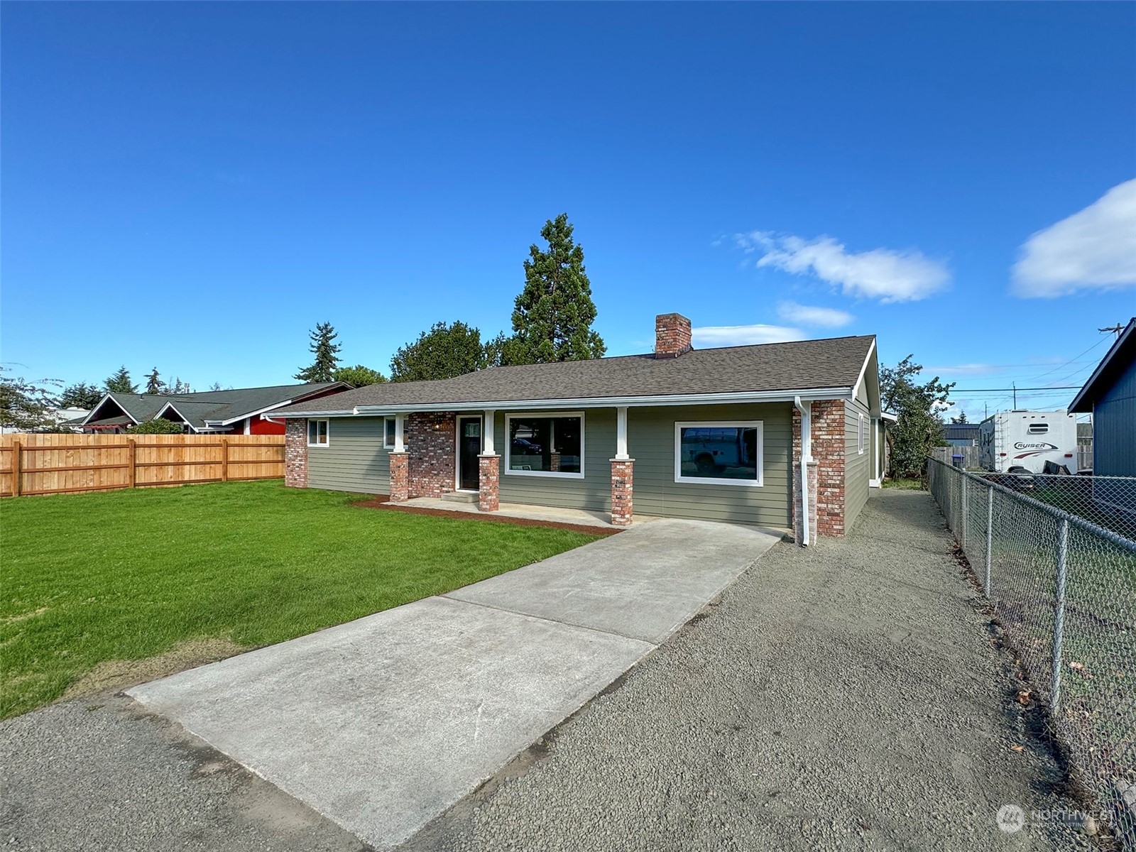 218 North Matriotti Avenue Sequim, WA 98382 - Photo 38 of 40 a front view of a house with a yard and garage