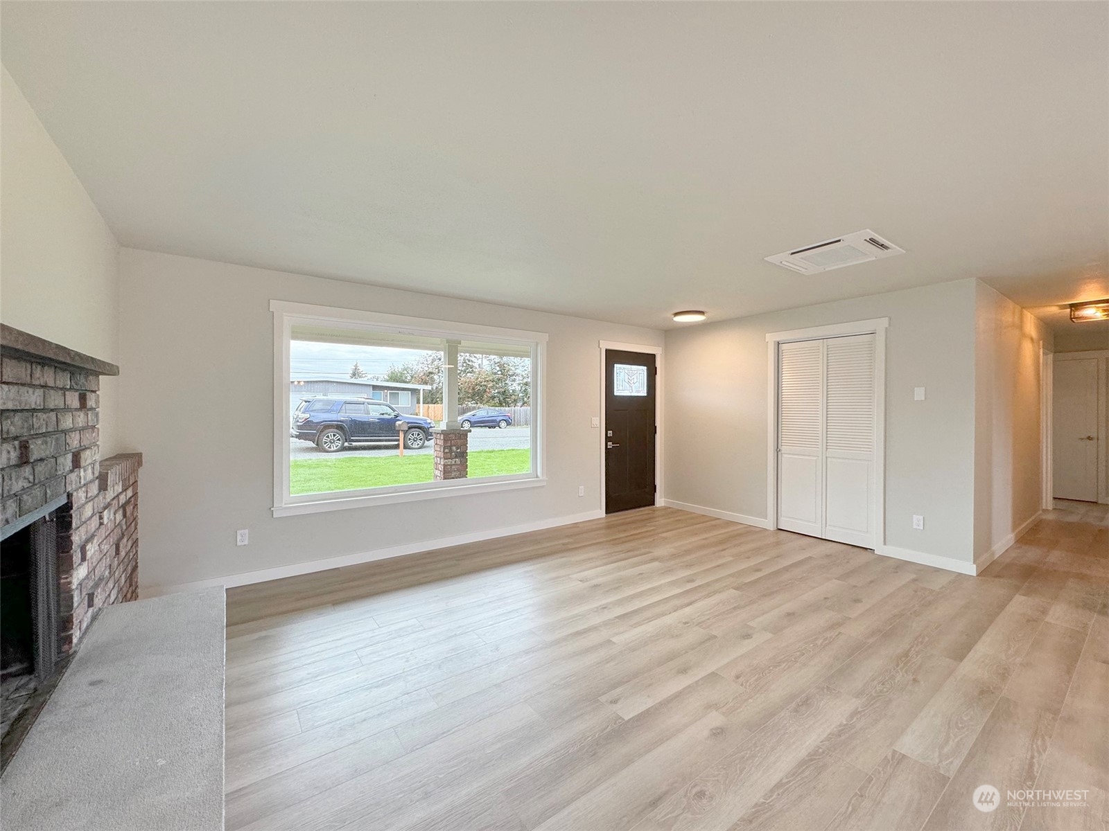 218 North Matriotti Avenue Sequim, WA 98382 - Photo 5 of 40 an empty room with windows and fireplace