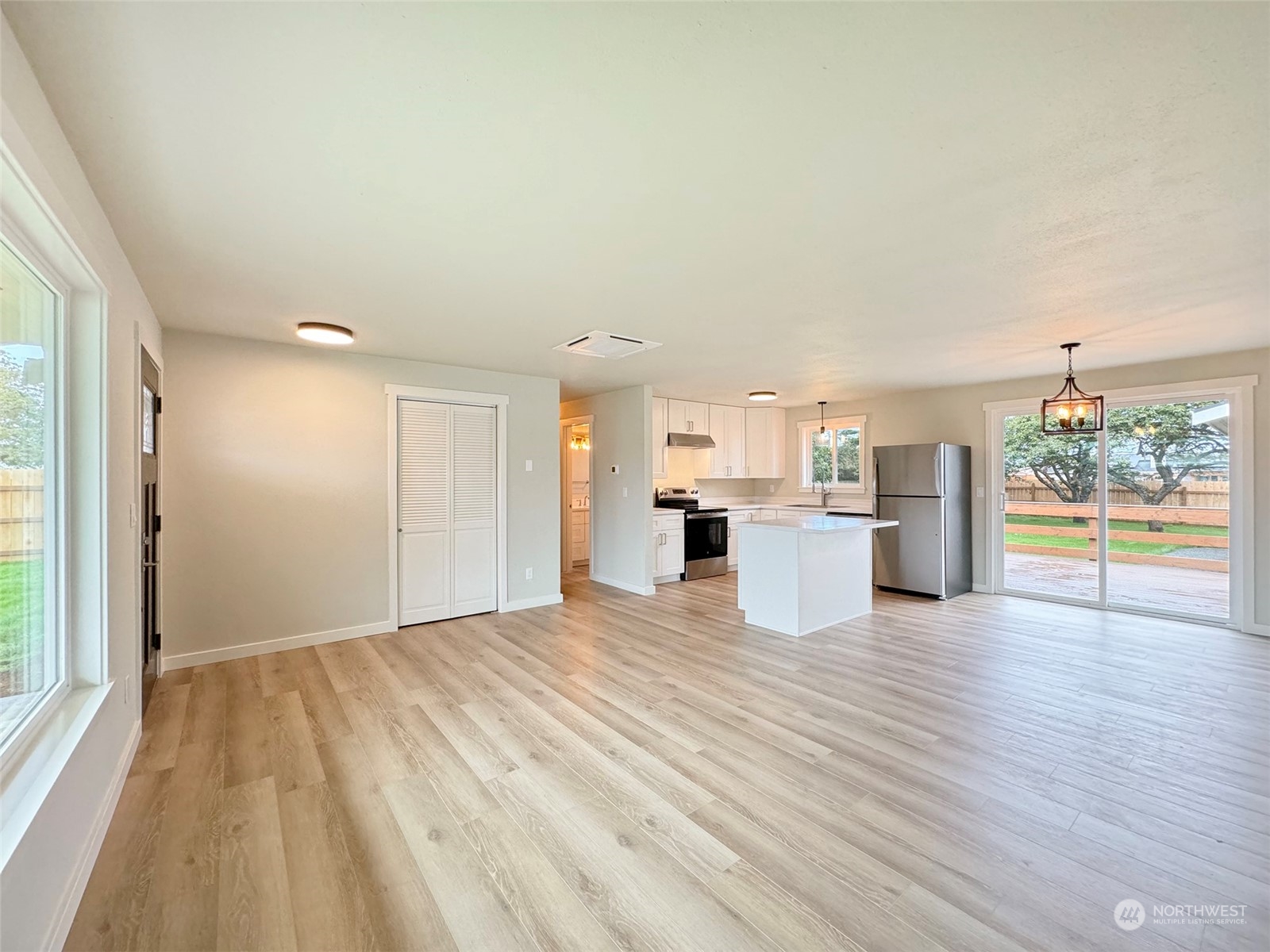 218 North Matriotti Avenue Sequim, WA 98382 - Photo 6 of 40 a view of a kitchen with wooden floor and windows