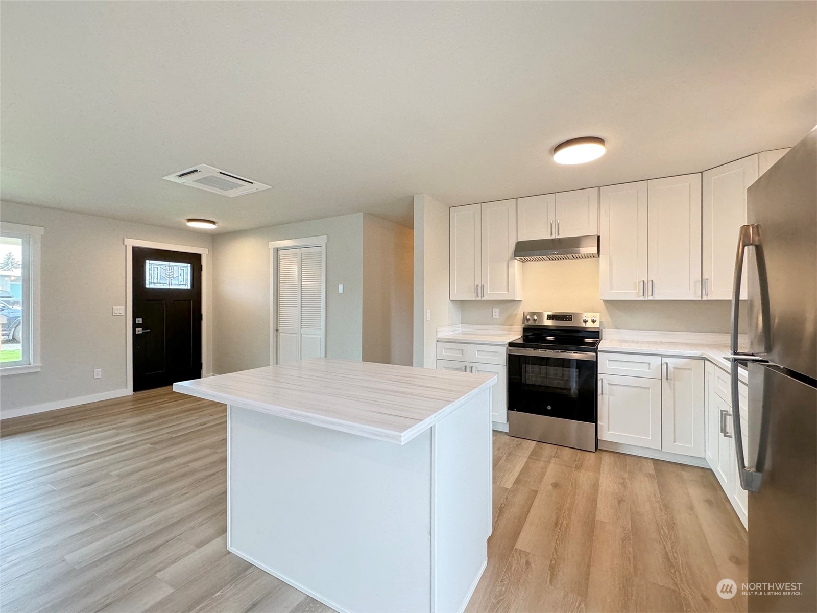 218 North Matriotti Avenue Sequim, WA 98382 - Photo 9 of 40 a kitchen with stainless steel appliances a refrigerator stove microwave and cabinets
