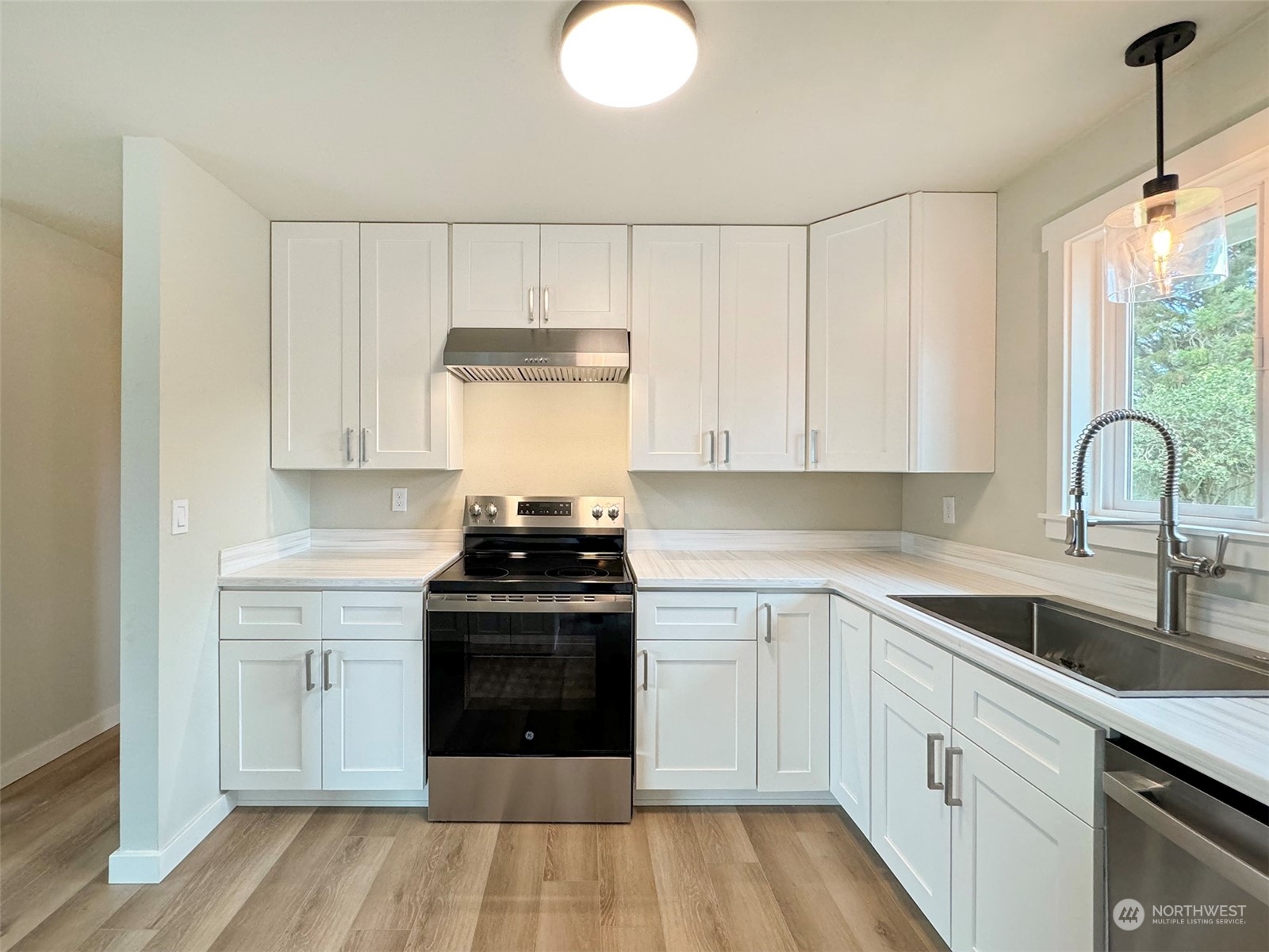 218 North Matriotti Avenue Sequim, WA 98382 - Photo 10 of 40 a kitchen with a sink stove and cabinets