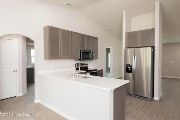 a kitchen with a refrigerator sink and microwave
