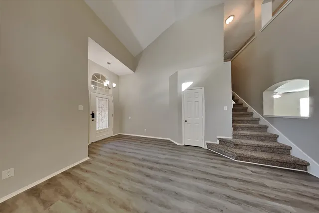 a view of an entryway with wooden floor