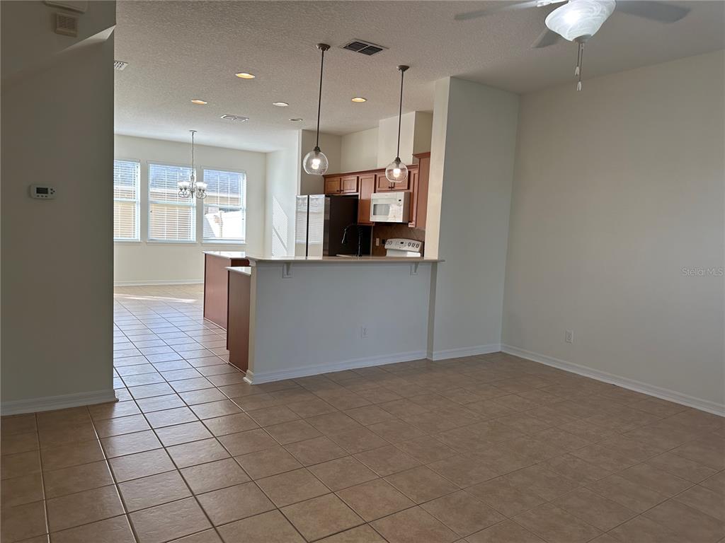 7668 Billingham Street Windermere, FL 34786 - Photo 2 of 15 an empty room with kitchen view and appliances