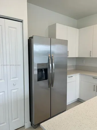 a kitchen with cabinets and stainless steel appliances