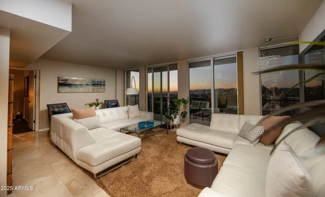 a living room with furniture and a large window