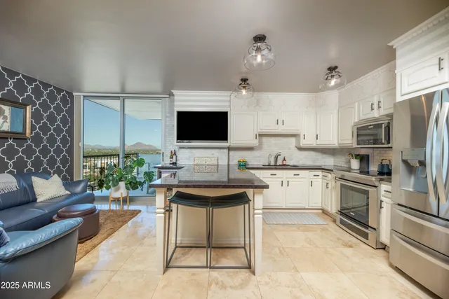 a kitchen with granite countertop white cabinets stainless steel appliances and sink