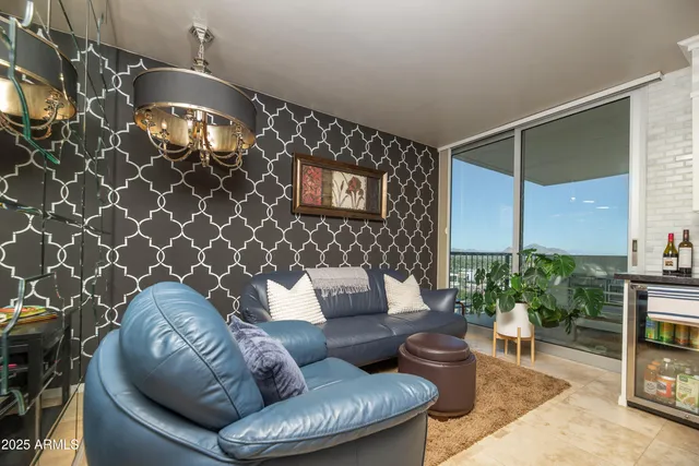 a bedroom with a bed a couch and a chandelier