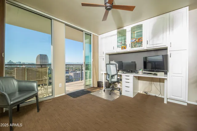 a view of a patio with a table and chairs under an umbrella