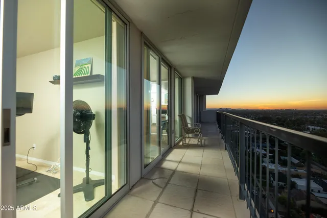 a view of a patio with a table and chairs under an umbrella