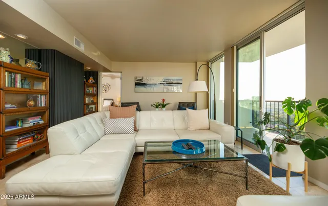 a living room with furniture and a large window