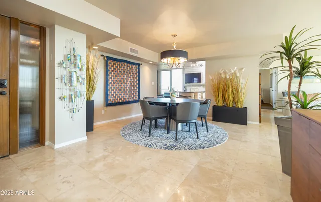 a kitchen with stainless steel appliances kitchen island granite countertop a sink a stove a dining table and chairs