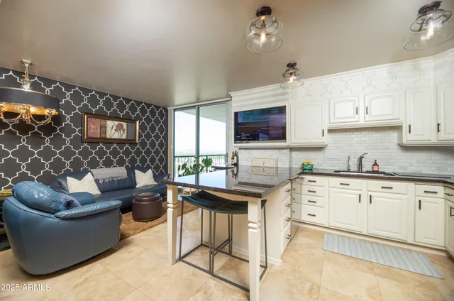 a kitchen with stainless steel appliances a stove a sink a microwave a refrigerator and cabinets