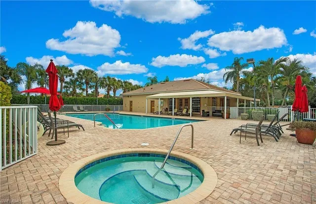a view of a house with swimming pool and sitting area