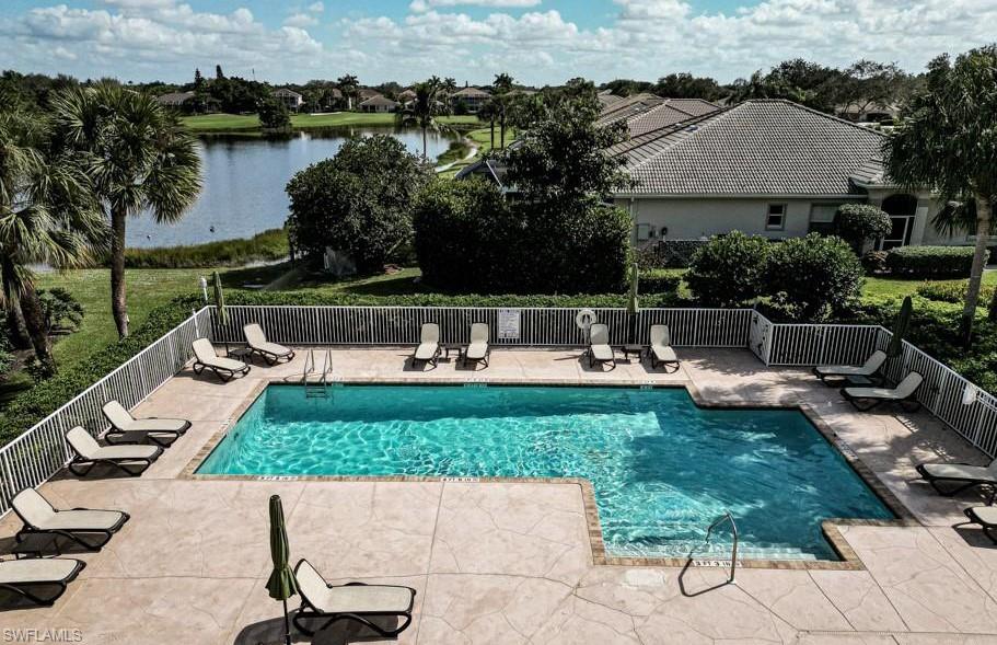 1837 Avian Court, Unit A71 Naples, FL 34119 - Photo 13 of 13 a view of swimming pool with outdoor seating and lake view