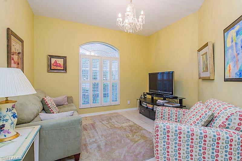 1837 Avian Court, Unit A71 Naples, FL 34119 - Photo 2 of 13 a living room with furniture and a flat screen tv