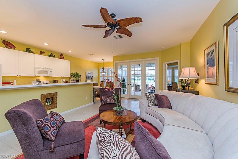 1837 Avian Court, Unit A71 Naples, FL 34119 - Photo 6 of 13 a living room with furniture and kitchen view