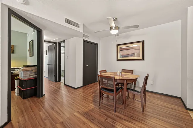 a view of a dining room with furniture and wooden floor