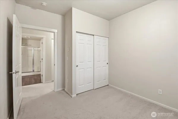 an empty room with closet area