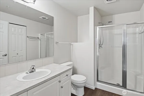 a bathroom with a sink toilet and shower