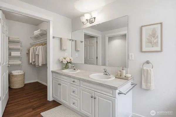 a spacious bathroom with a granite countertop sink and a mirror